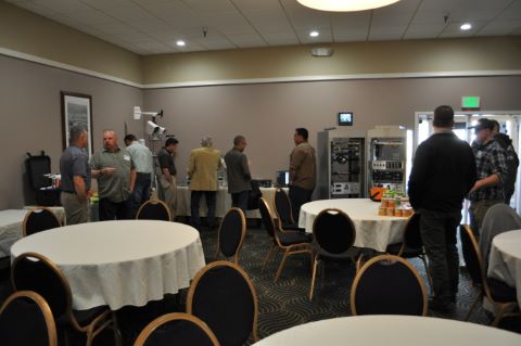 People in small groups looking at ITS equipment and talking to each other.