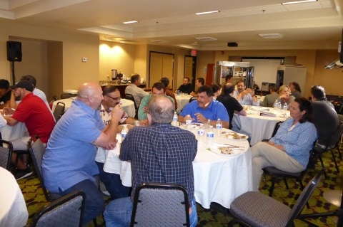 People seated at round tables.